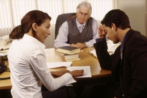 Divorcing Couple Sitting in Lawyer's Office