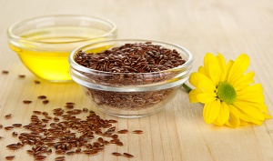 Useful linseed oil on wooden table close-up